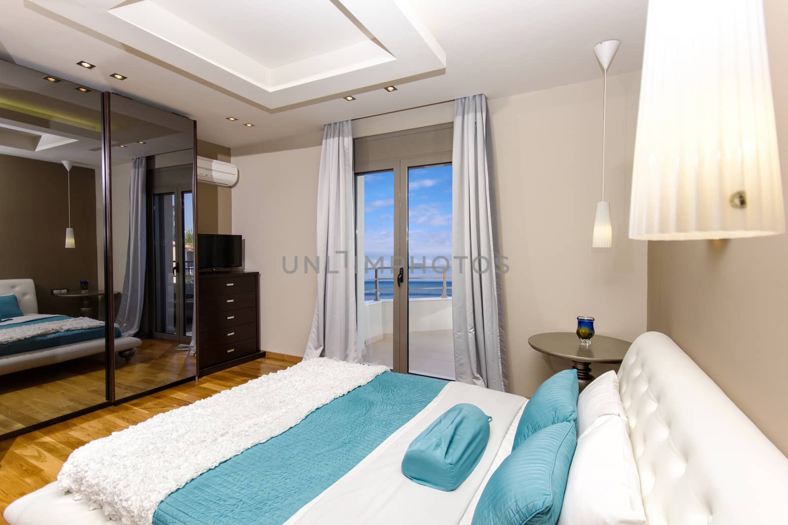 interior of a luxury bedroom with a beautiful sea view