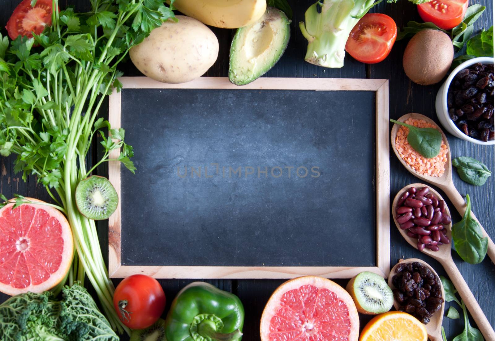Fresh organic around a chalkboard with space
