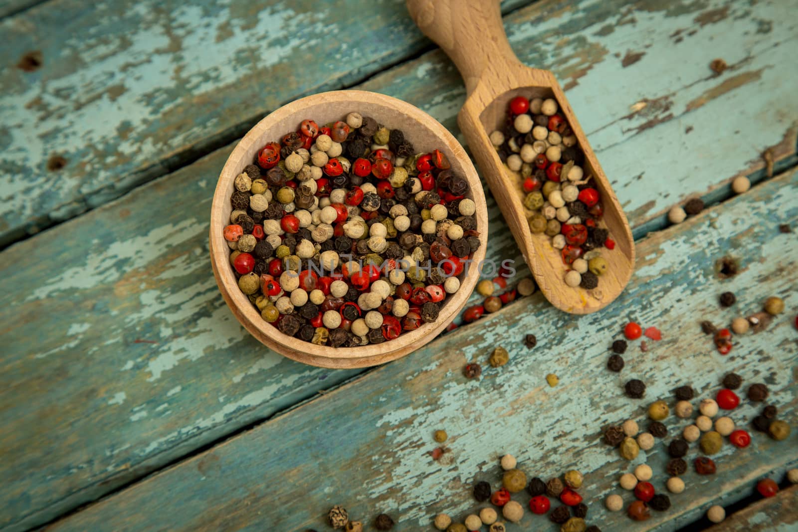 Mixed peppercorns in a wooden bowl.