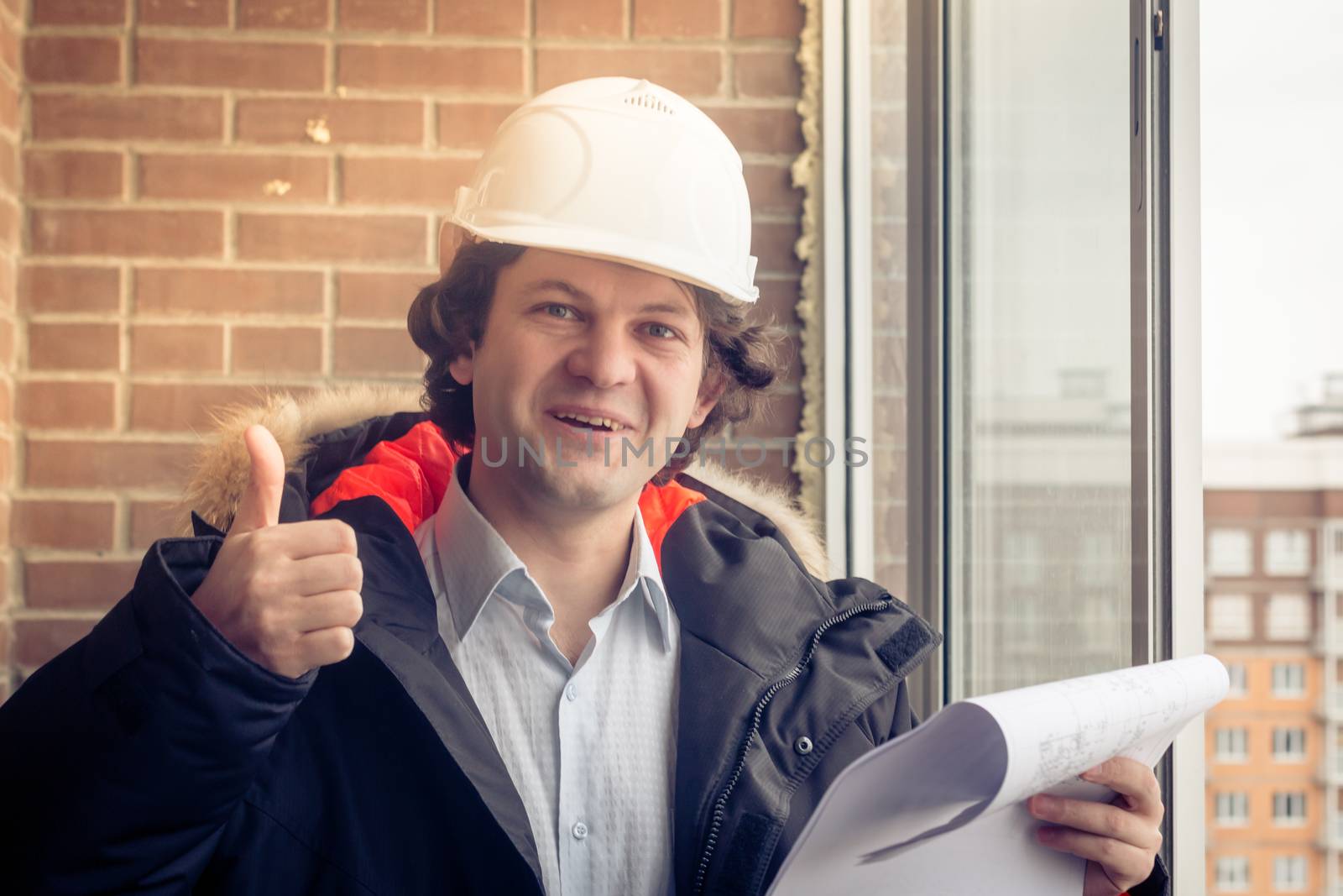 Happy Caucasian Construction Worker Giving Thumb Up. Soft focus, toned