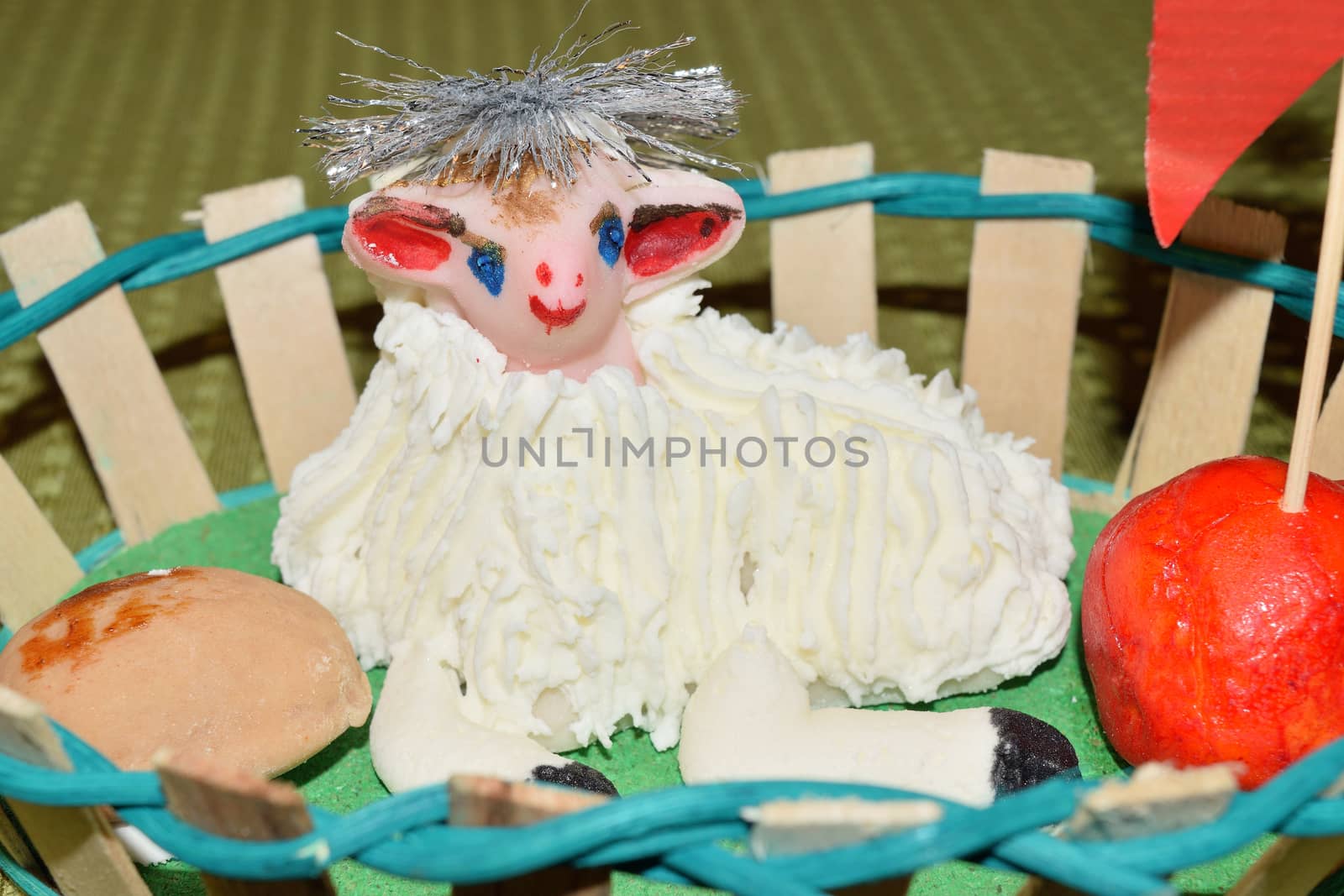 close up of marzipan Easter lamb and fruit in a basket by solosergio
