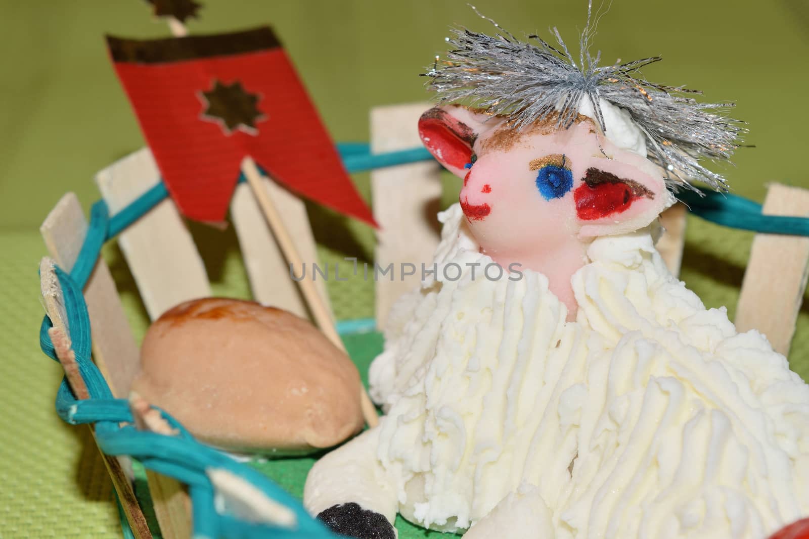 close up of marzipan Easter lamb and fruit in a basket