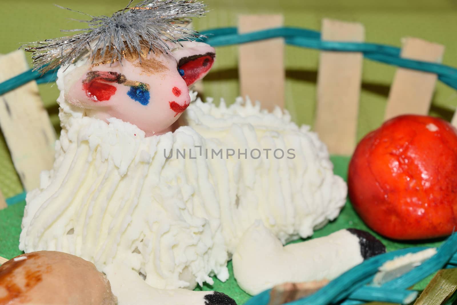 close up of marzipan Easter lamb and fruit in a basket by solosergio