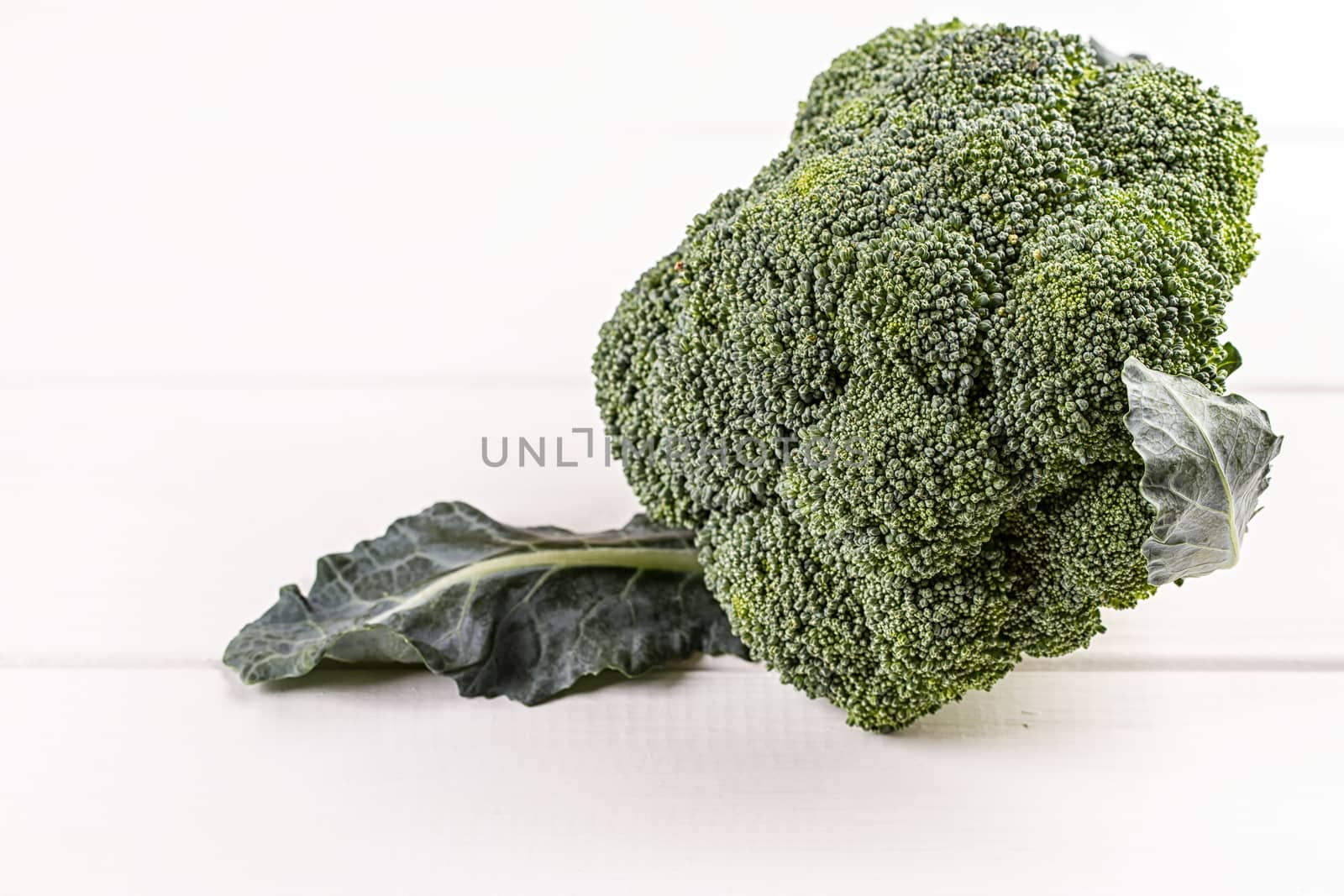 Fresh broccoli on white wooden table background
