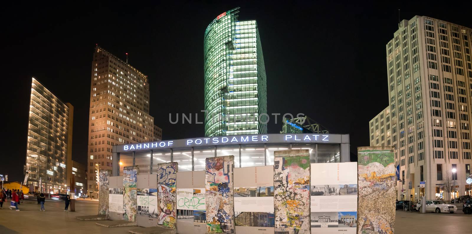 BERLIN, GERMANY - JANUARY 4 2016: Postdamer Platz with a monument fron the wall and modern buildings on the background at night