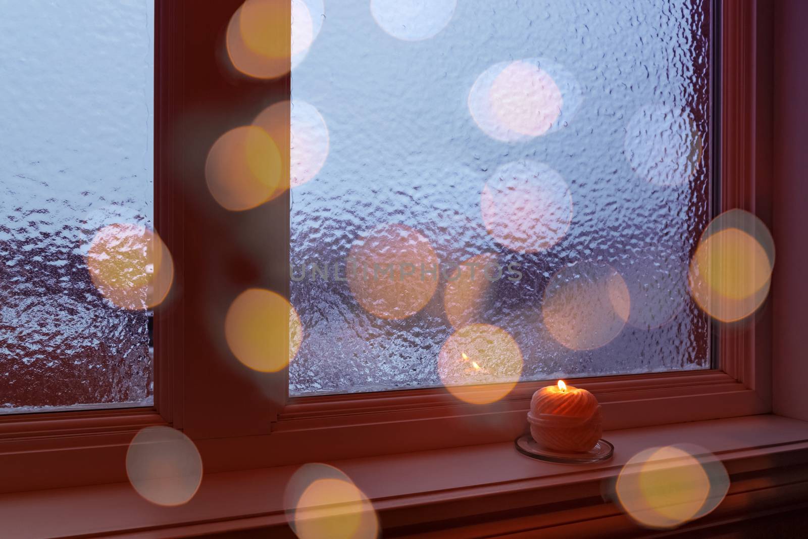 Cozy frosted window, candle and bokeh lights by anikasalsera