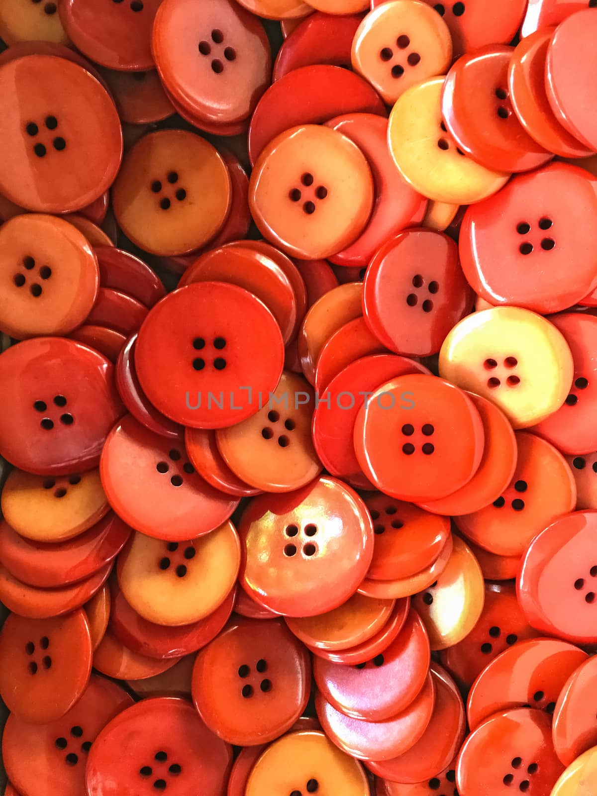 Background of plastic red and orange buttons.