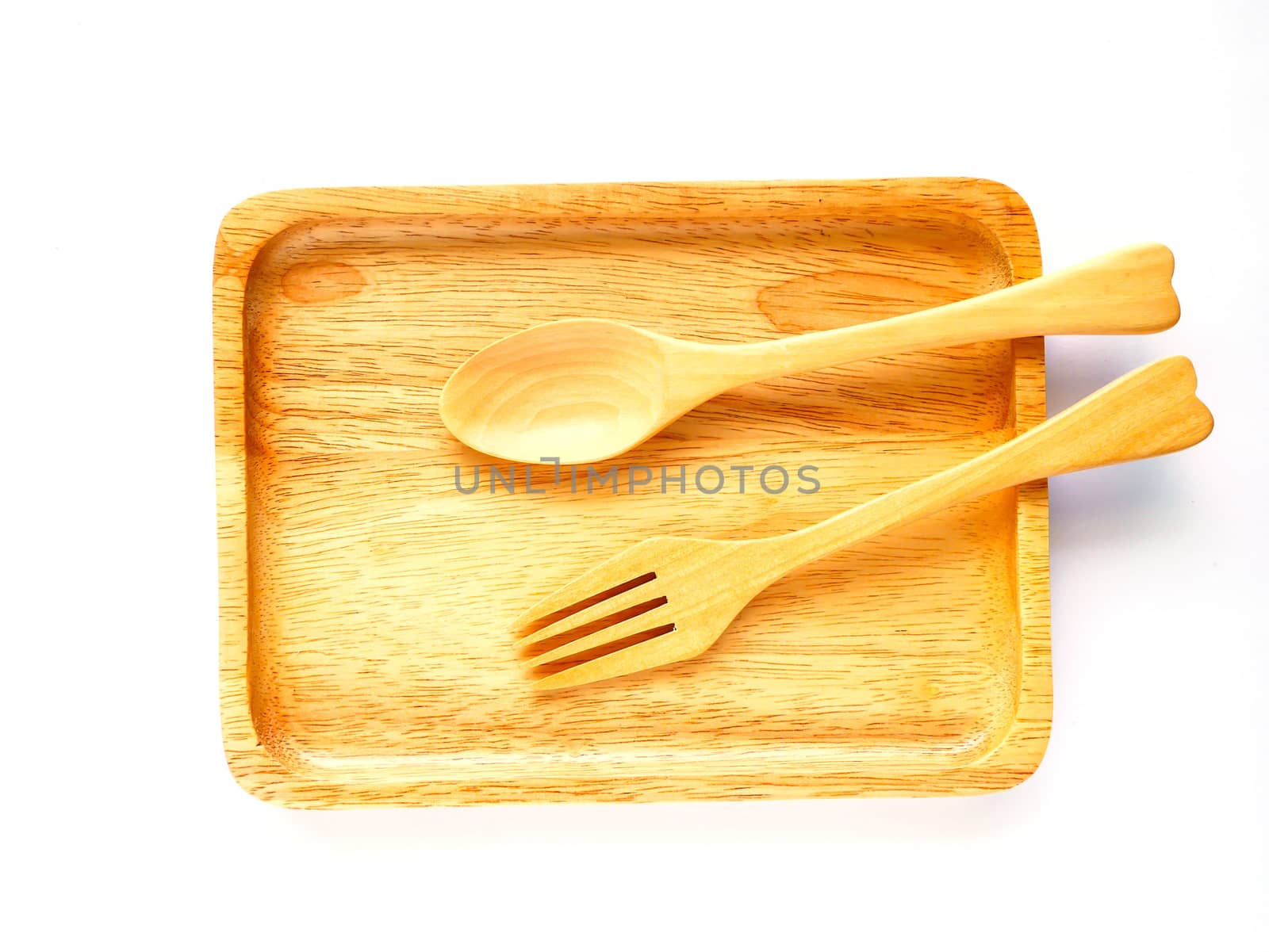 Wooden plate and spoon on white backgound