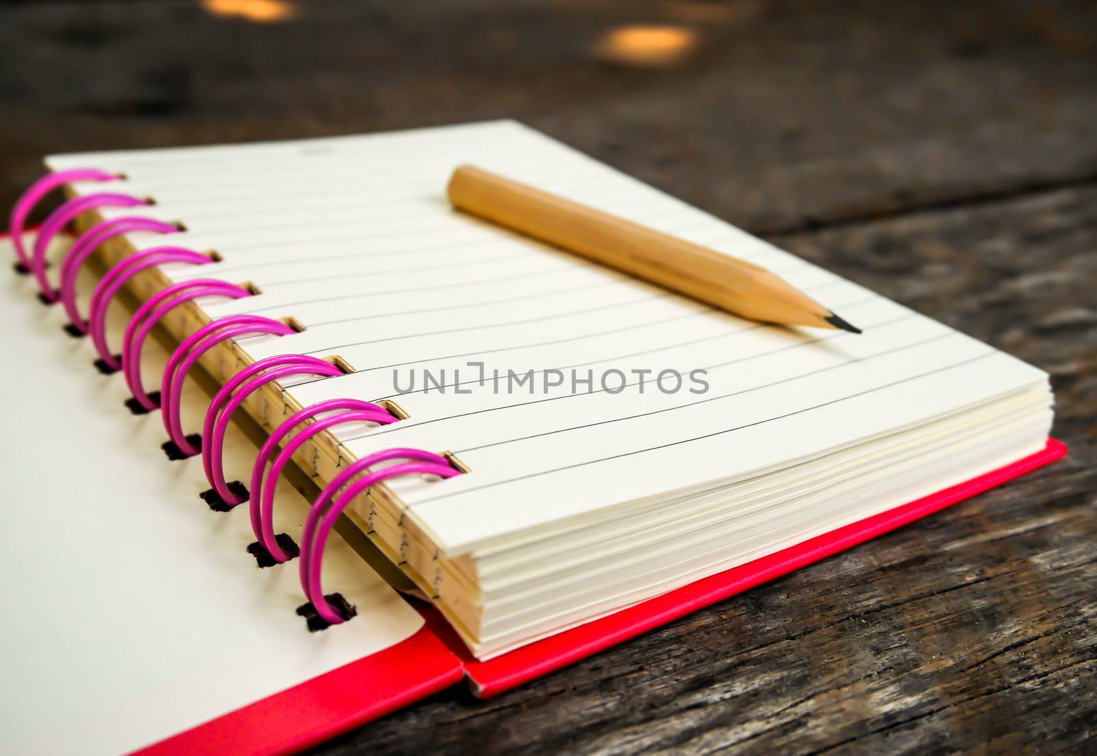 Focus note book with pencil on wooden table