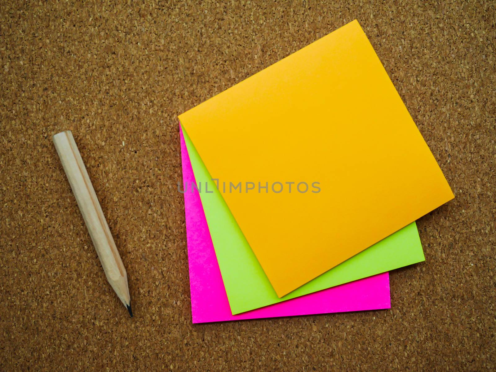 Three post note and pencil on wooden board