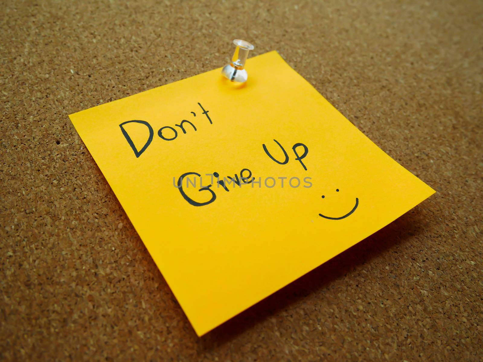 Don't give up in post note on wooden board