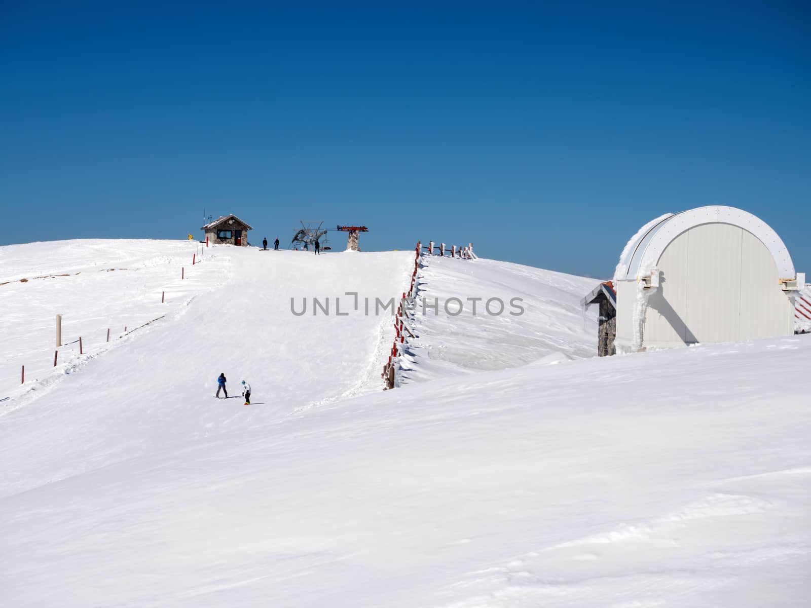 Snowboarders and skiers at the top of the mountain in Kalavrita ski resort
