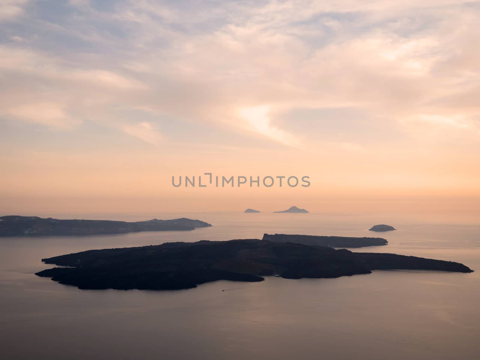 View of the sunset and the volcano of Santorini island in Cyclades,Greece