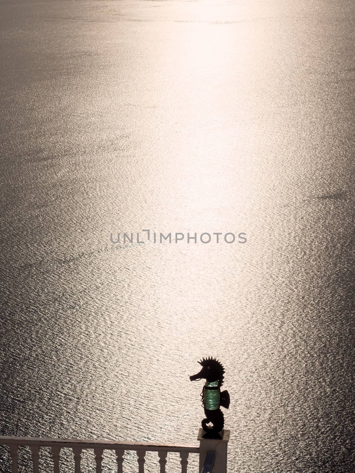 Balcony with statue silhouette in Santorini island in Cyclades, Greece