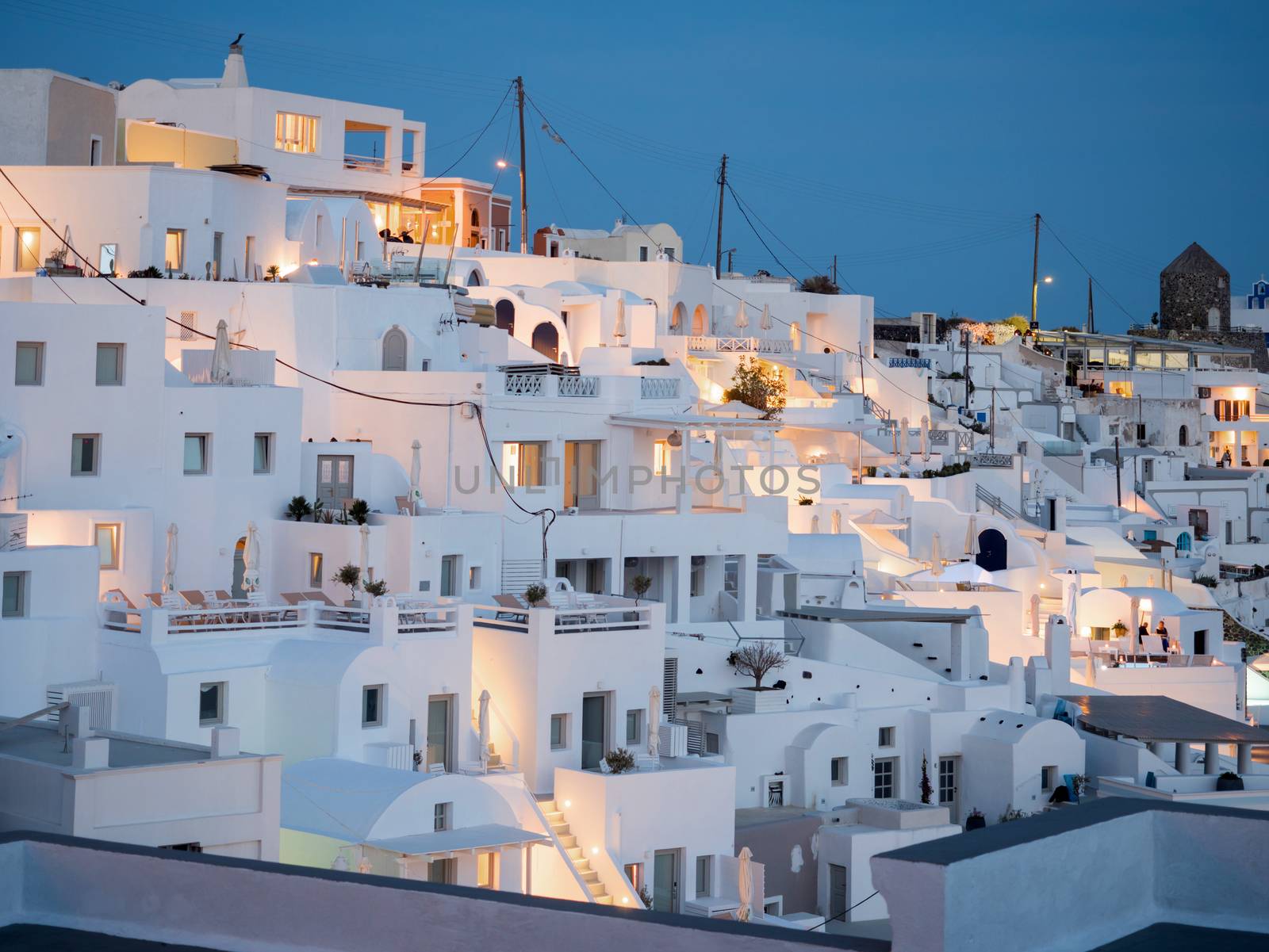Small white houses with lights late in the afternoon in Santorini island in Cyclades,Greece