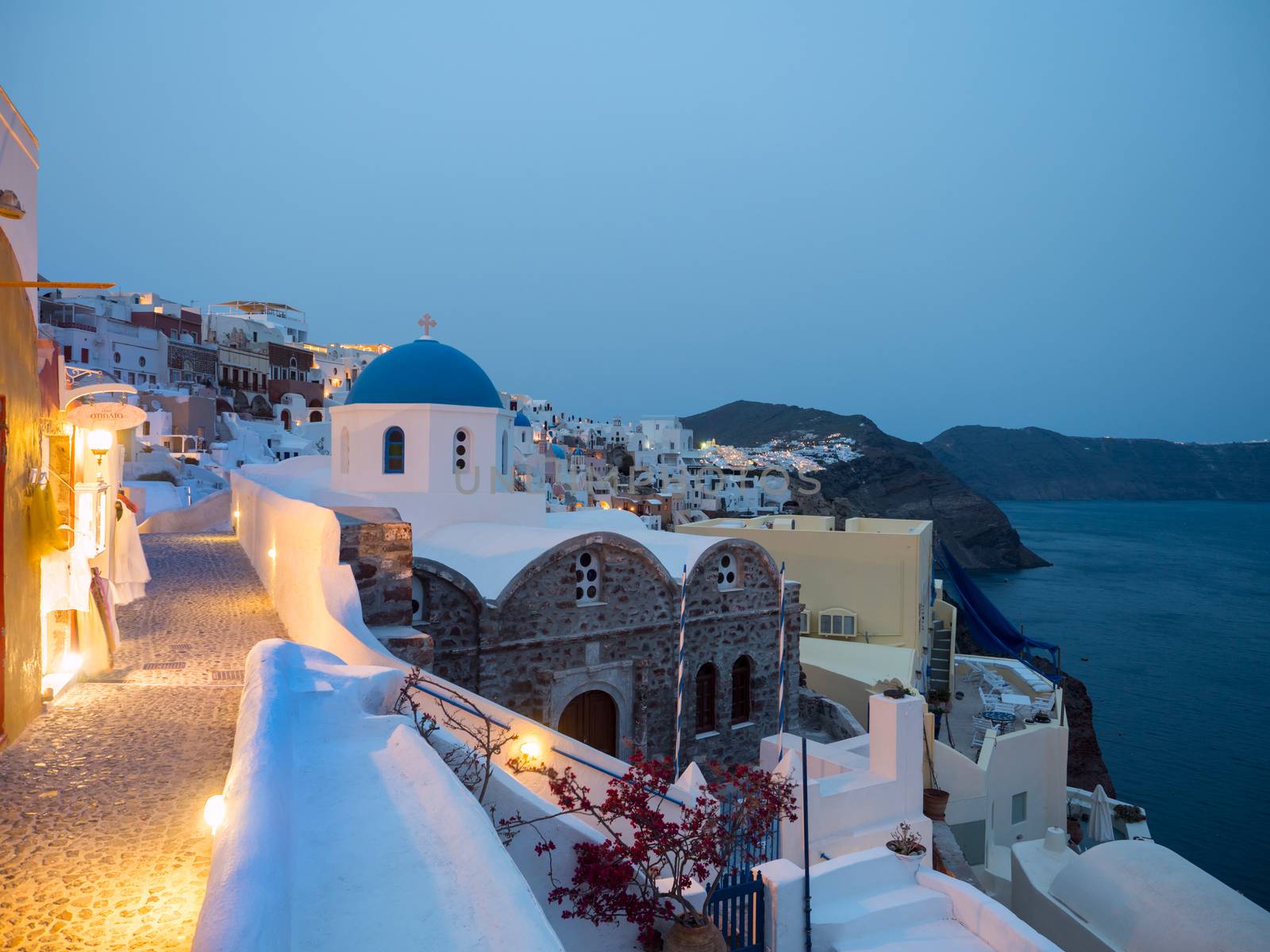 Small white houses with lights late in the afternoon in Oia, Santorini island,Greece