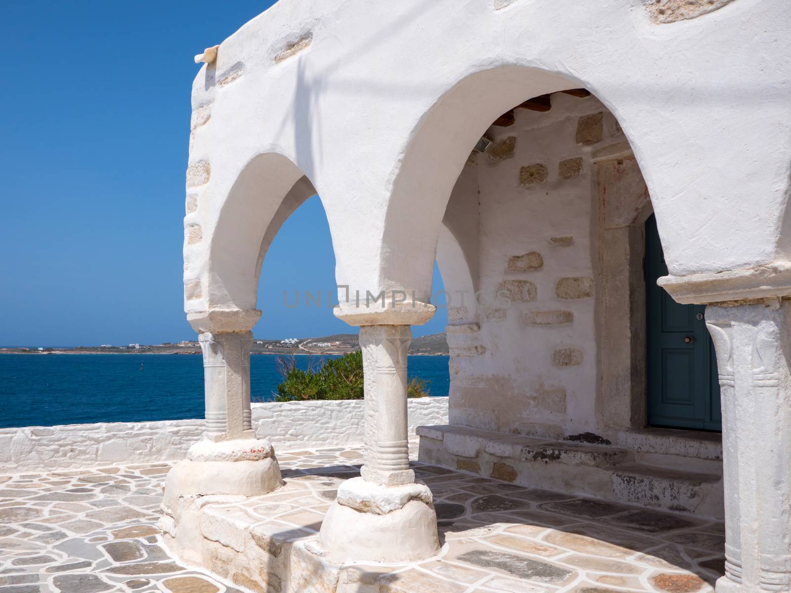 Small white church by the sea in Paros, Greece