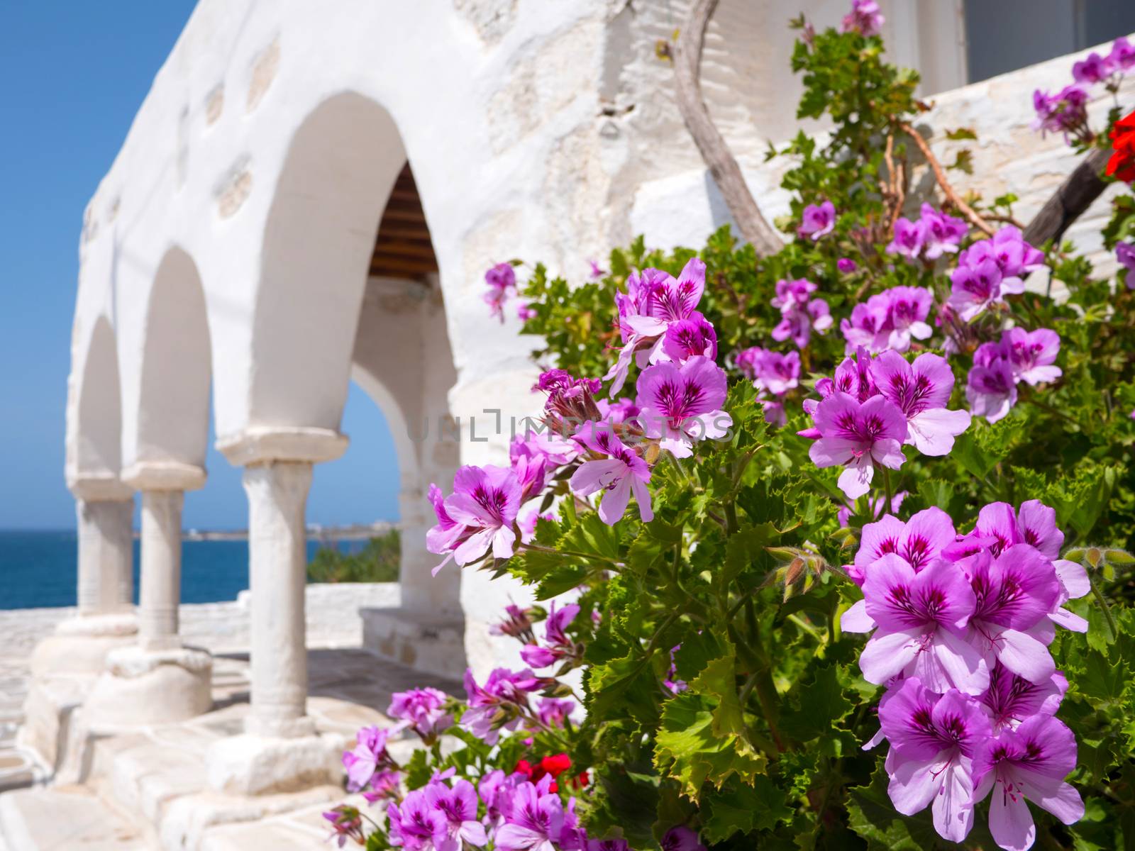 Small white church by the sea in Paros, Greece