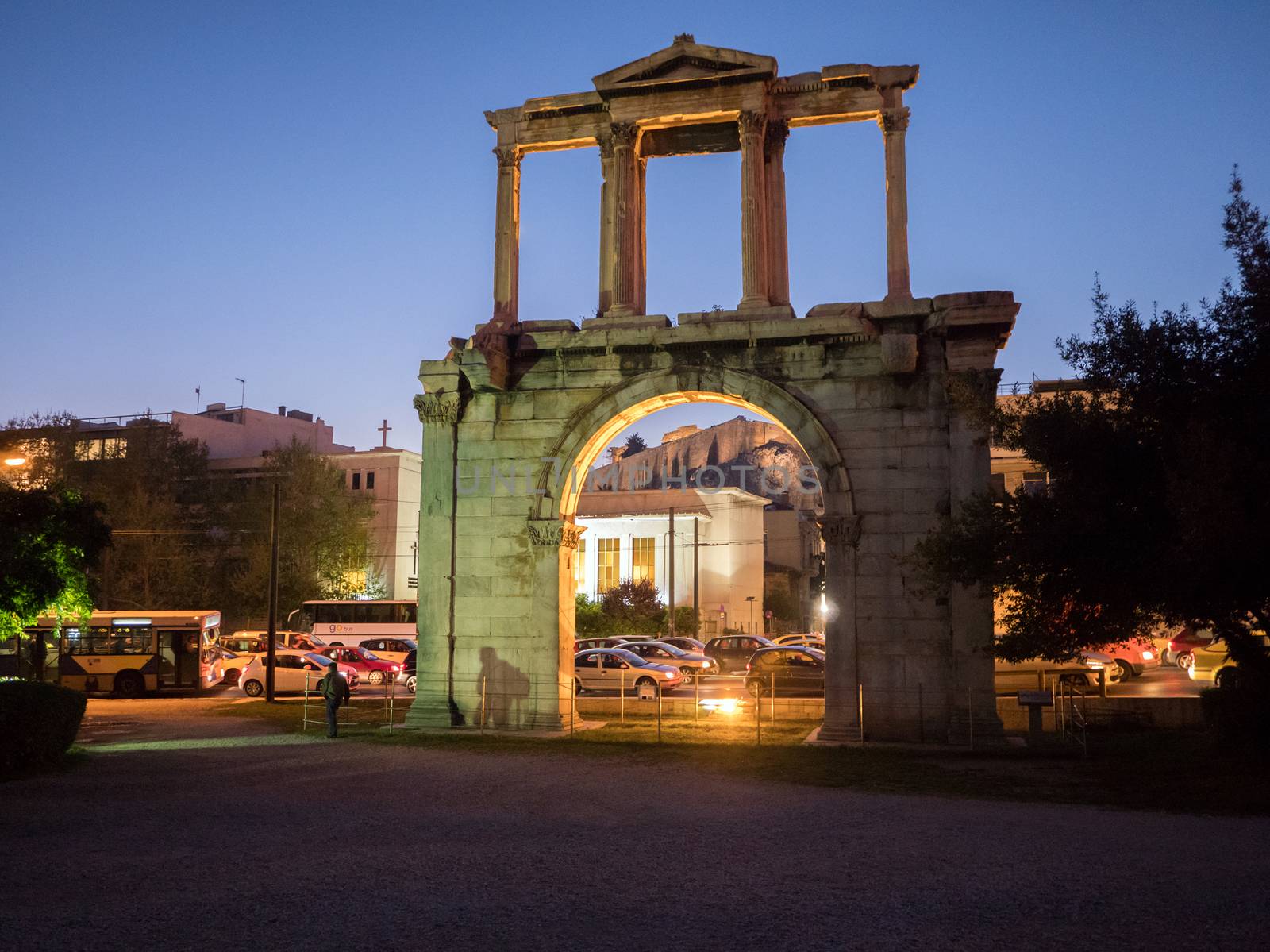 Hadrian's gate illuminated at night with Acropolis on the background in the historic center of Athens, Greece