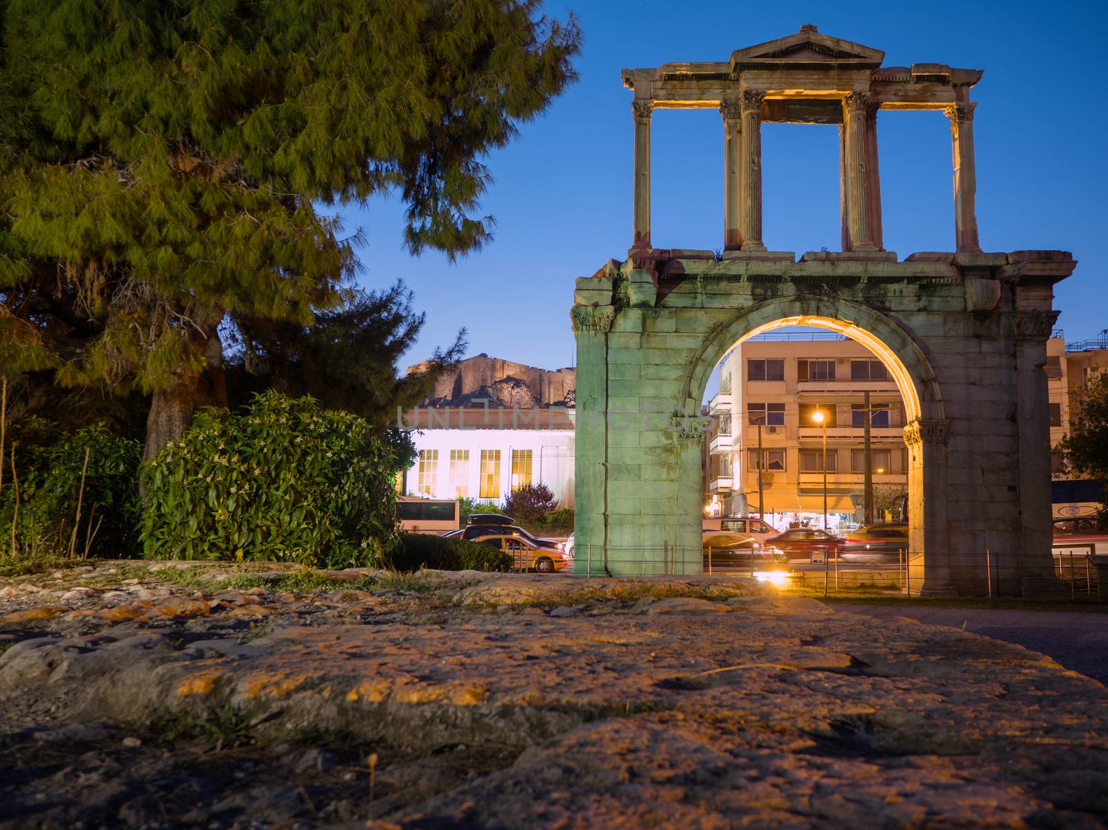 Hadrian's gate illuminated at night with Acropolis on the background in the historic center of Athens, Greece