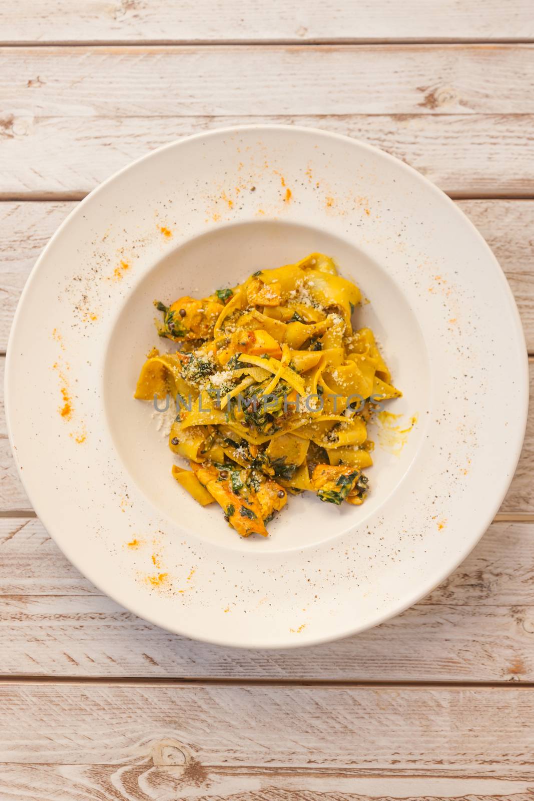 Gourmet fresh pasta with lentil served on a white plate