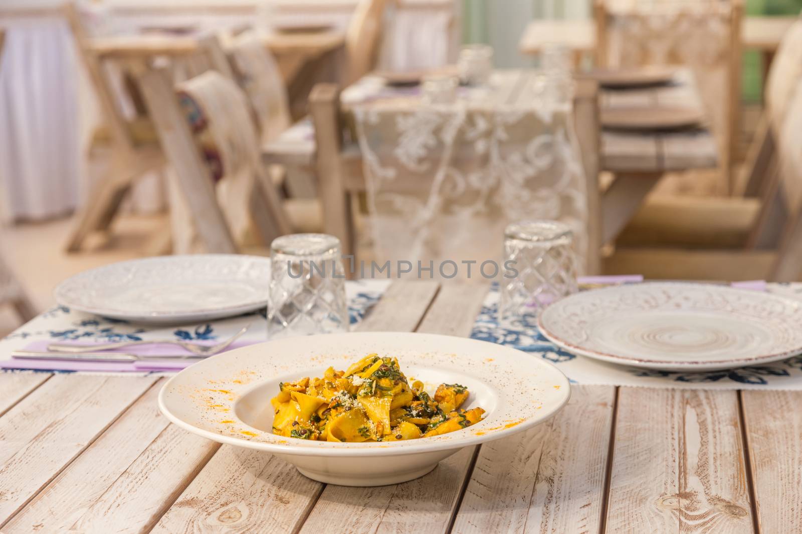 Gourmet fresh pasta with lentil served on a white plate