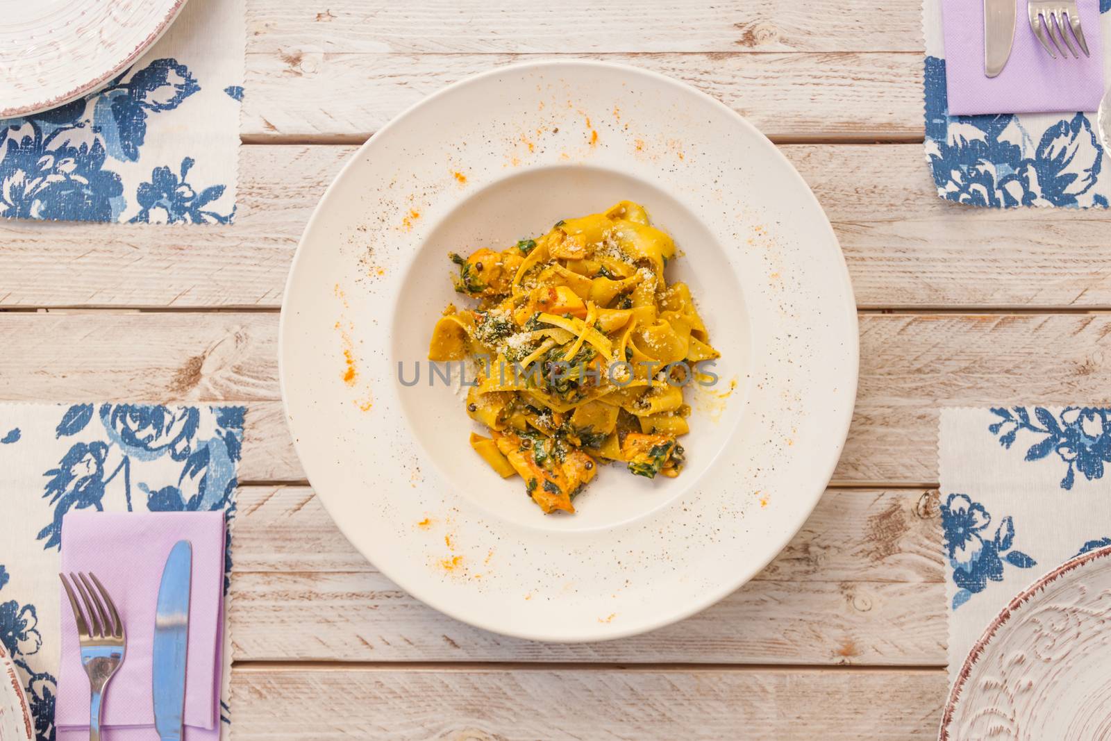 Gourmet fresh pasta with lentil served on a white plate