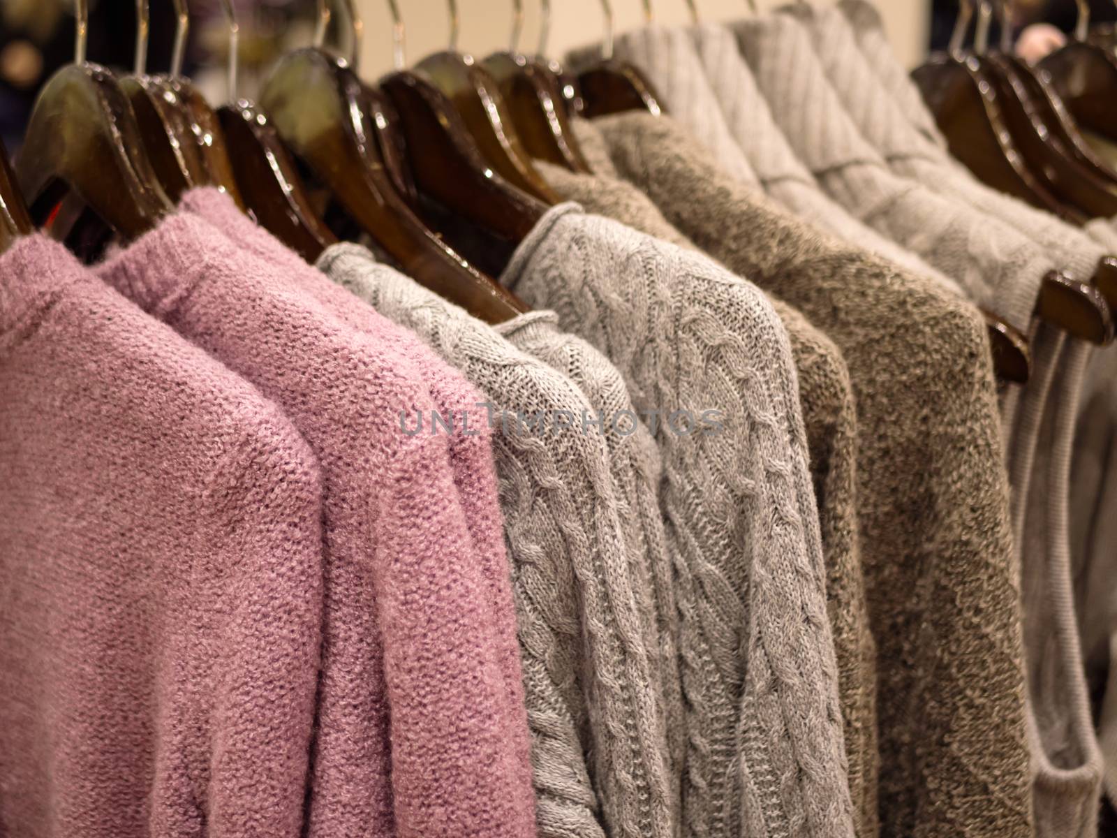 Close up of colorful knitted shirts stacked in a retail shop