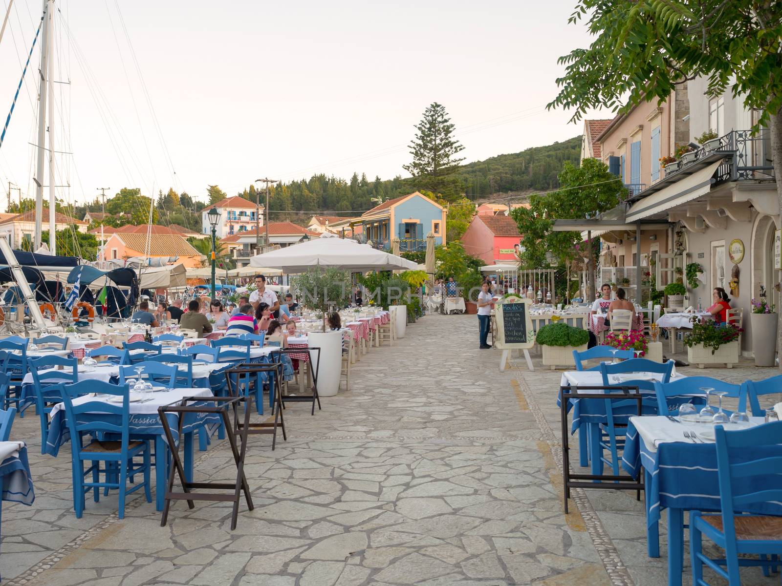 FISKARDO, GREECE - AUGUST 20, 2016: The port of Fiskardo village with greek restaurants in Kefalonia island