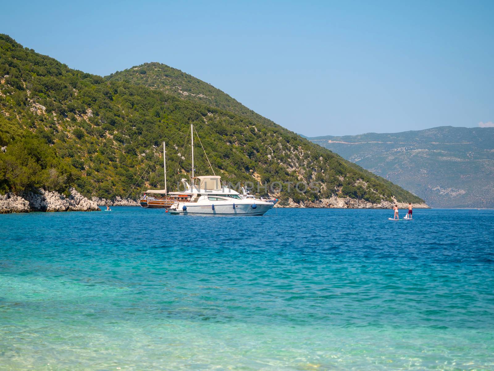 Boats in a shore and people enjoy the summer in Kefalonia island, Greece