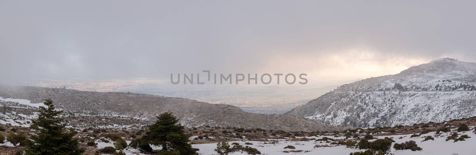 Panoramic view of Parnitha mountain landscape with snow and cloudy sky, Athens, Greece