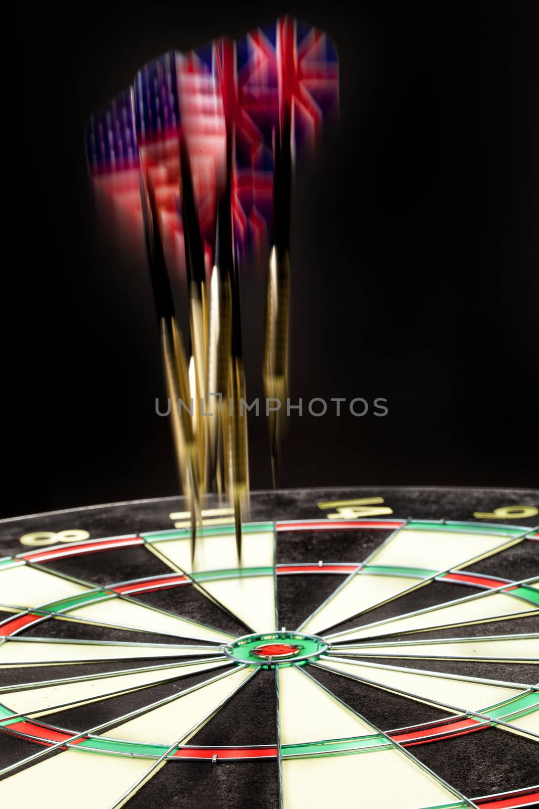 Indoor game Darts on a black studio background