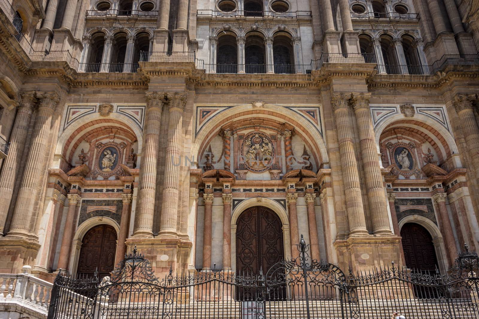 Baroque design of the main doors to the Malaga Cathedral in Malaga, Andalusia, Spain, Europe on a bright summer day