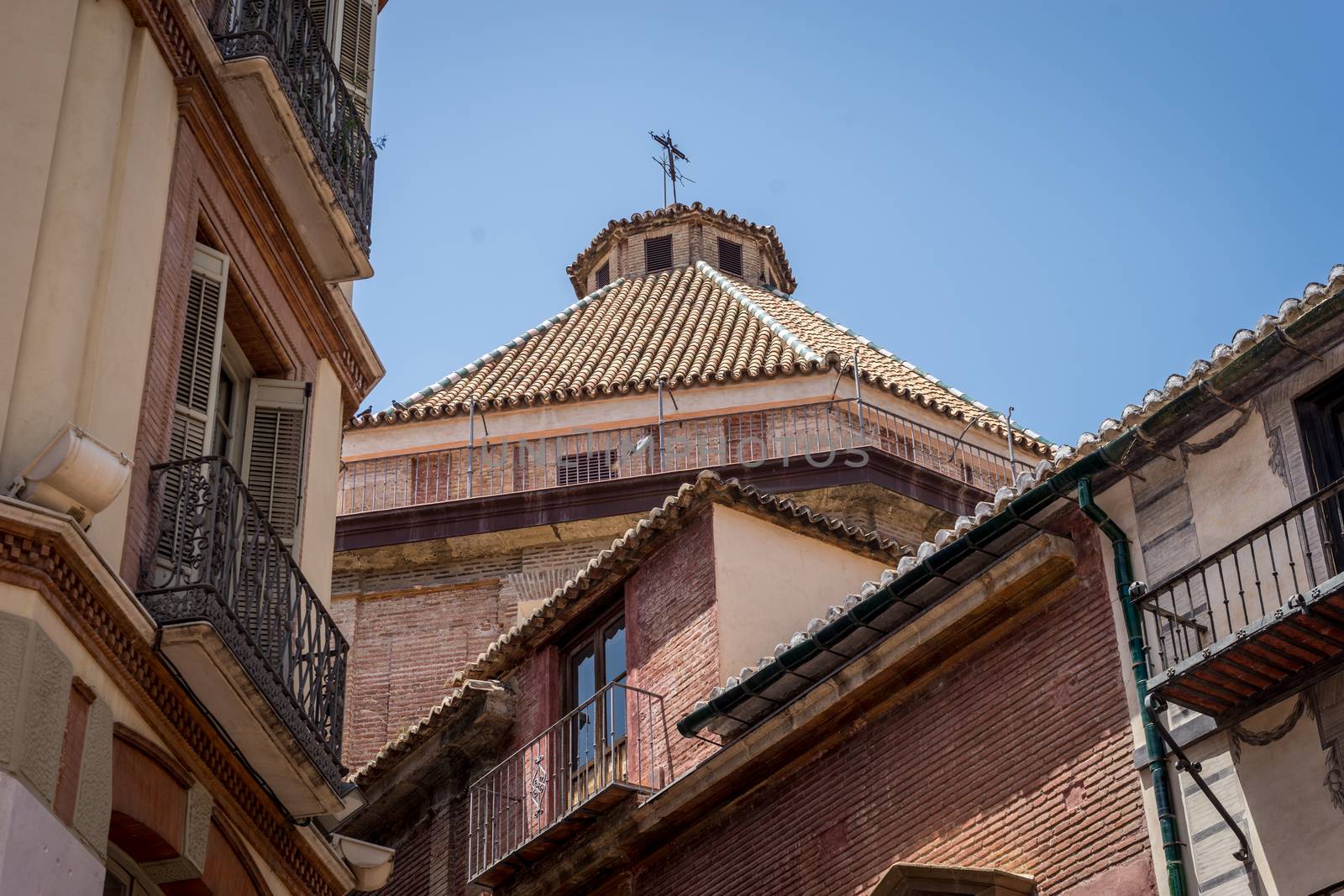 Sloping rooftop of a church in Malaga, Spain, Europe on a bright summer day with clear blue sky