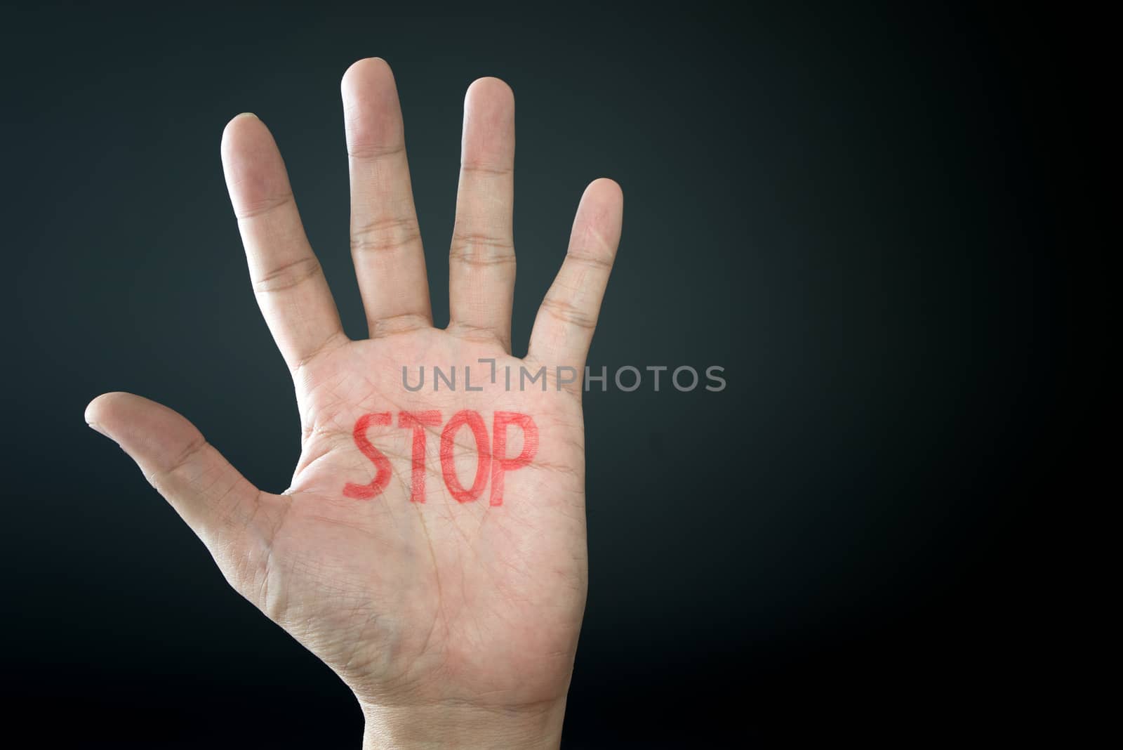 Hand with stop sign isolated on black background