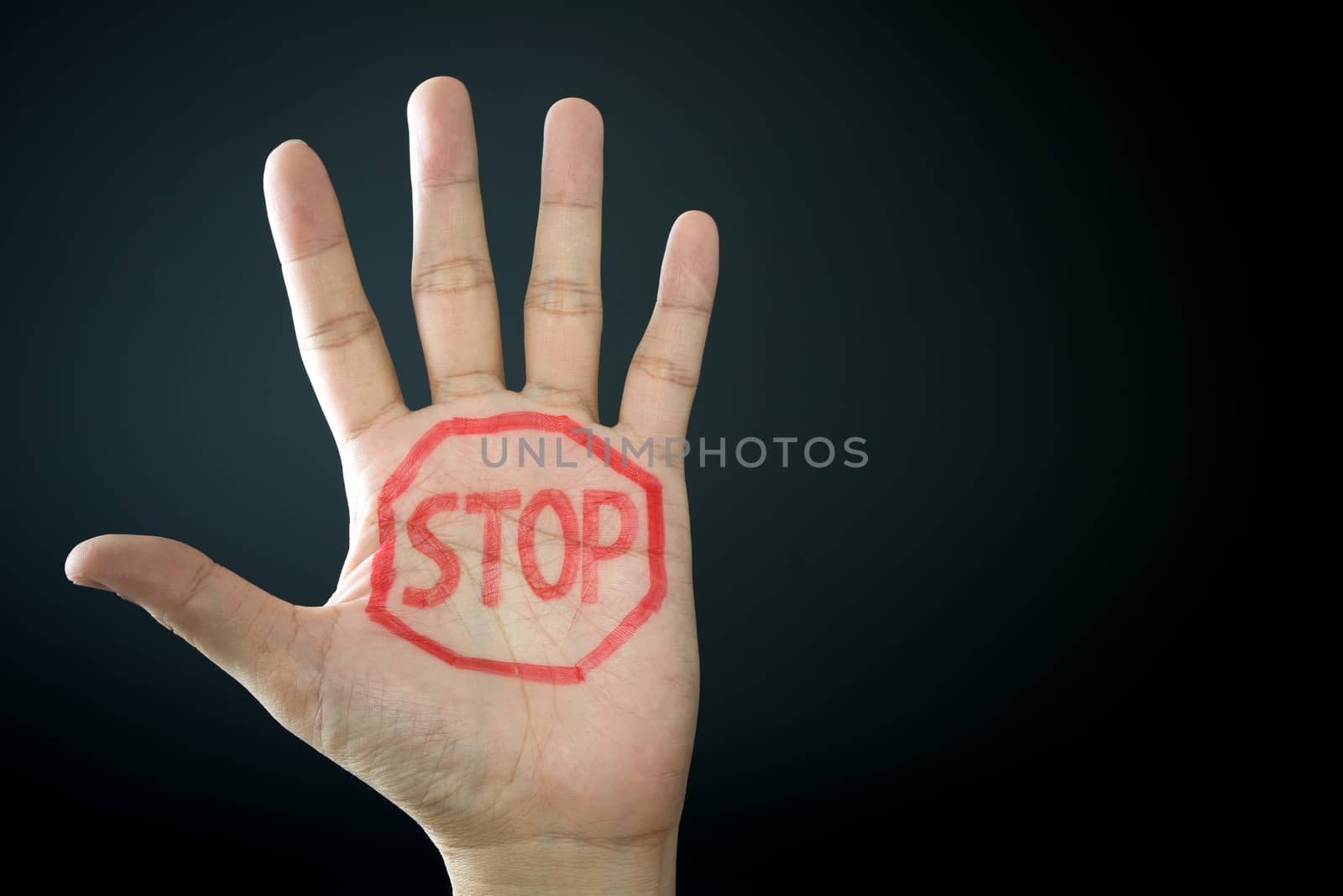 Hand with stop sign isolated on black background