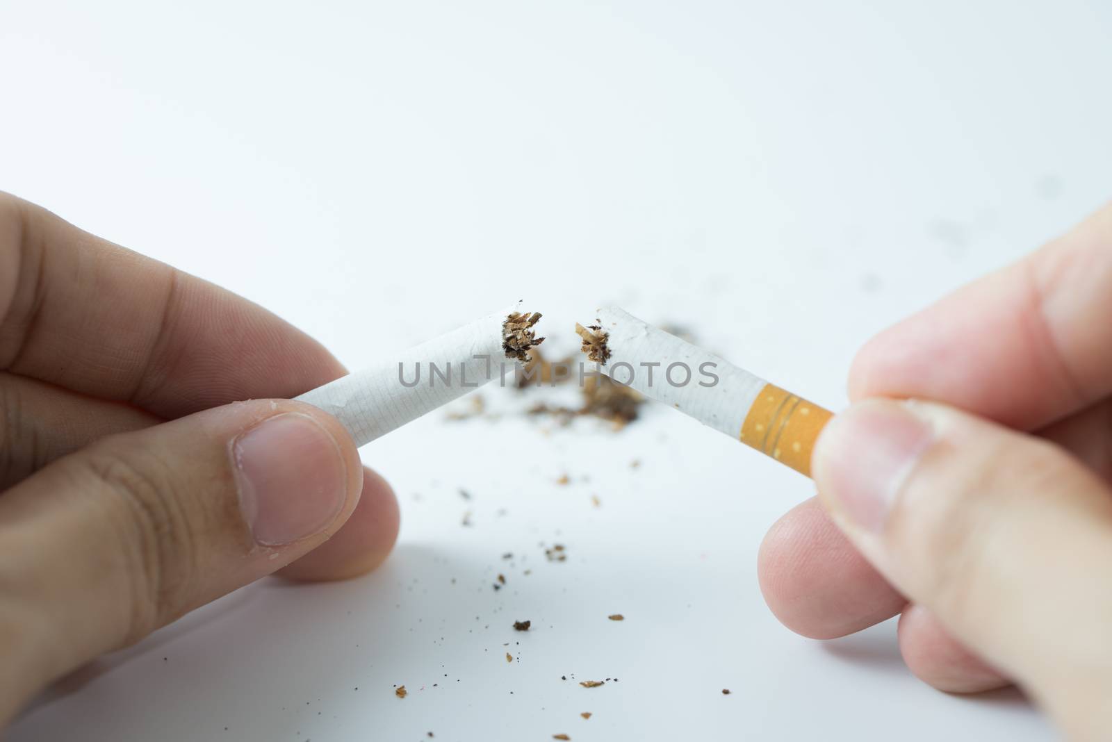 Quit smoking concept by breaking the cigarette by Kenishirotie