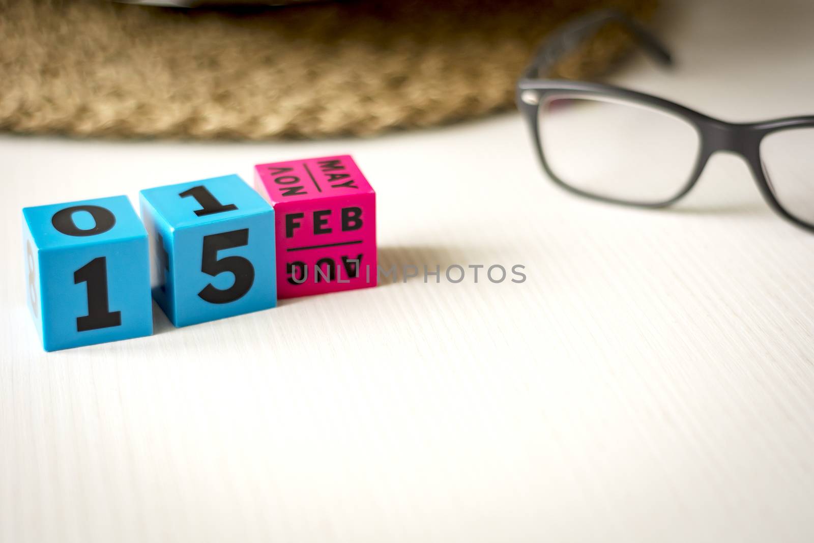 modern perpetual calendar composed of colored cubes and set at the date of February 15th