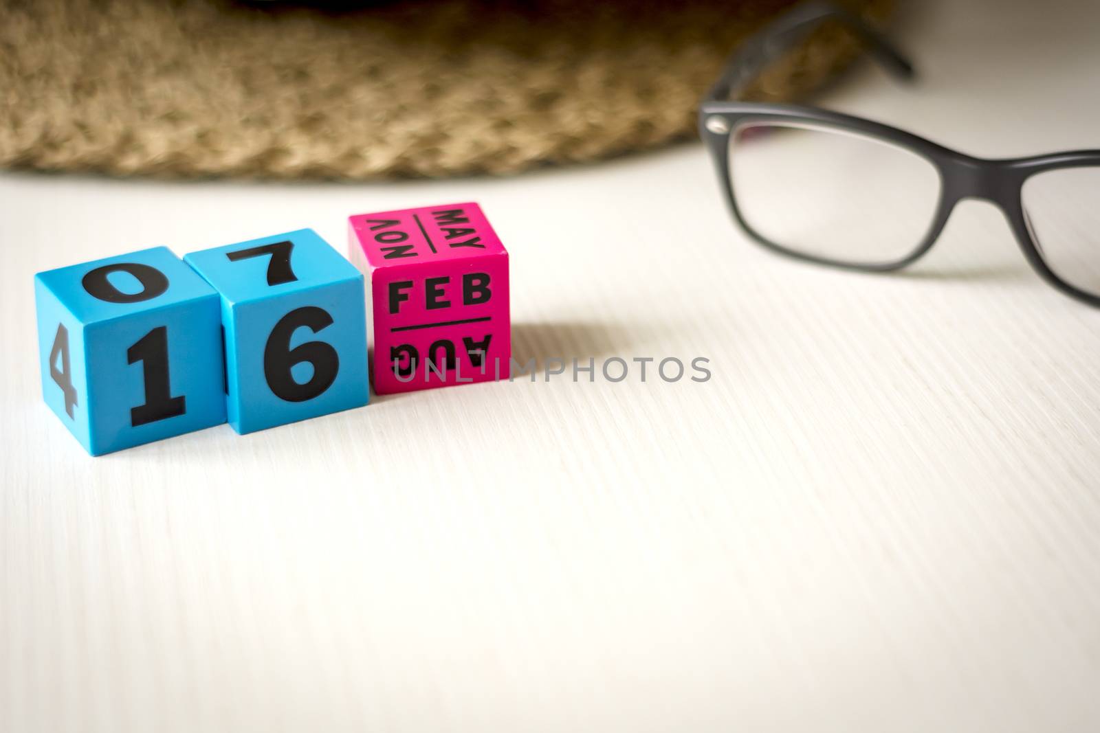 modern perpetual calendar composed of colored cubes and set at the date of February 16th