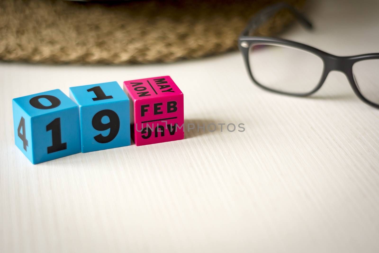 modern perpetual calendar composed of colored cubes and set at the date of February 19th