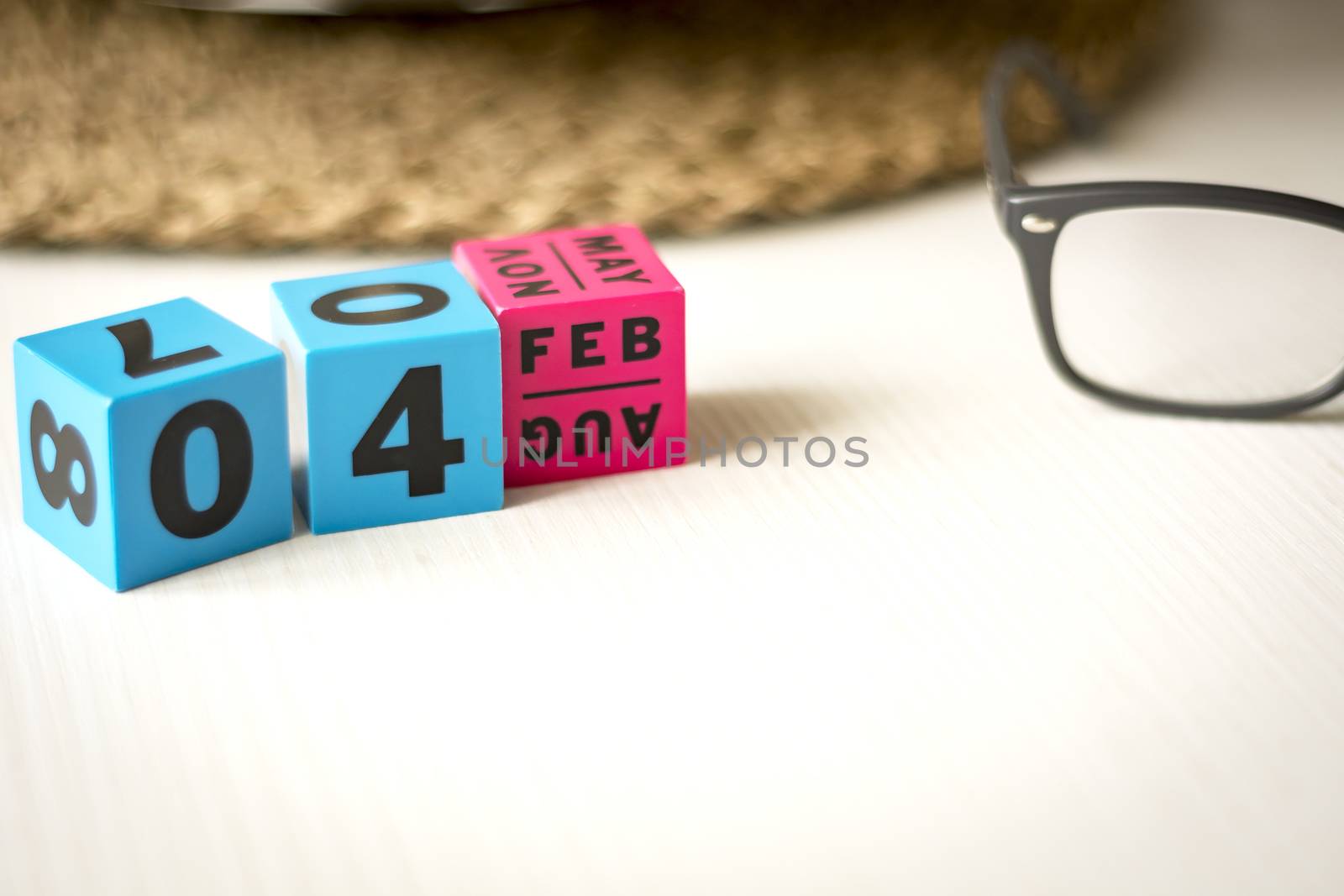 modern perpetual calendar composed of colored cubes and set at the date of February 4th