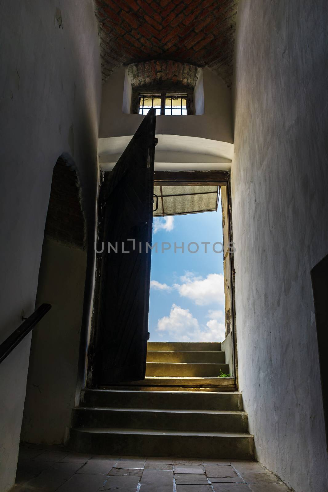 steps through open door in to the sky. view from inside of Palanok castle in Mukachevo, Ukraine