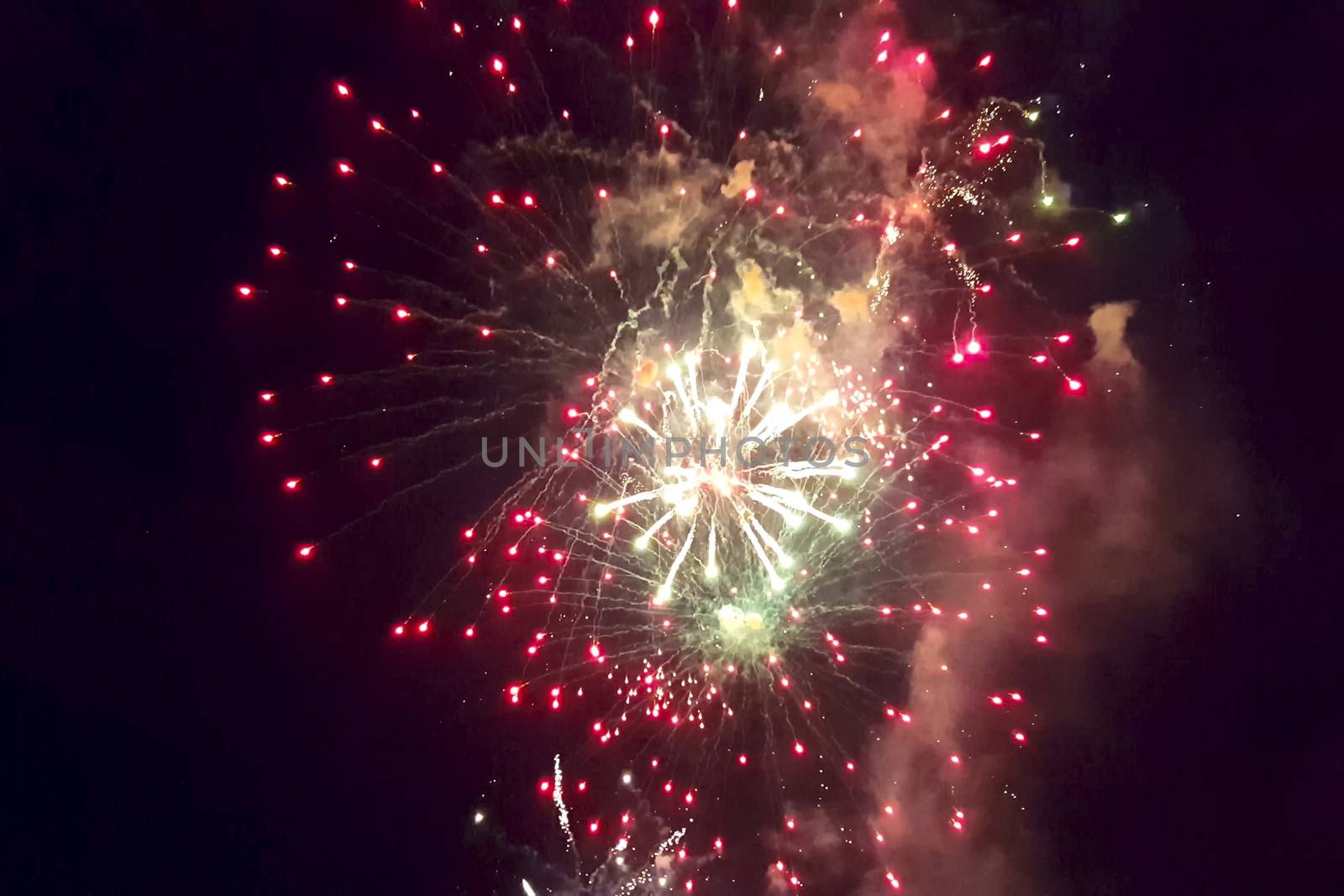 Festive salute in the night sky. Explosions of fireworks.