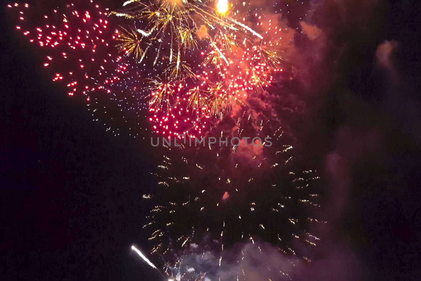 Festive salute in the night sky. Explosions of fireworks.