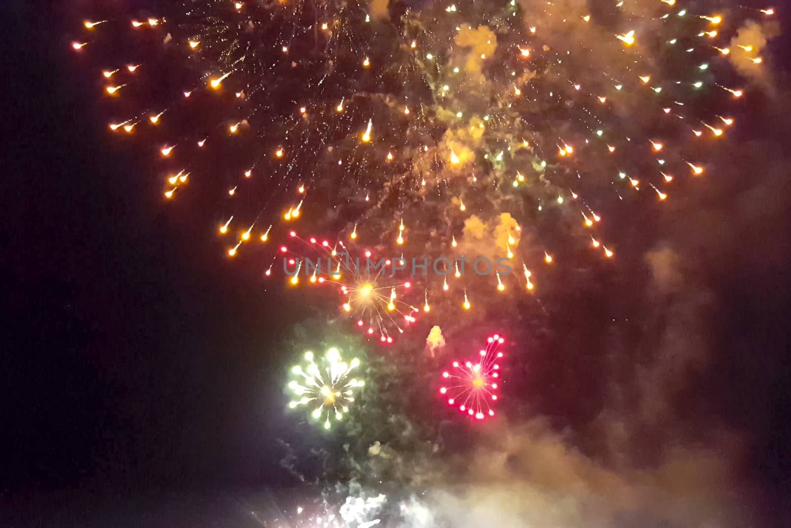 Festive salute in the night sky. Explosions of fireworks.