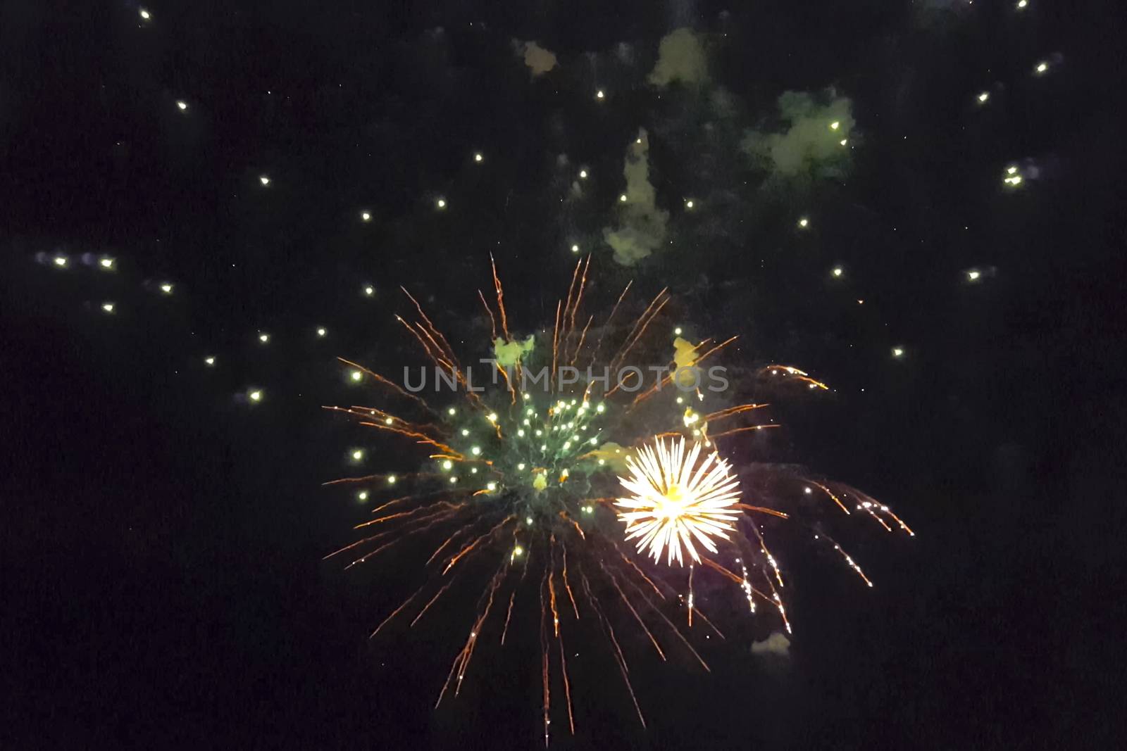 Festive salute in the night sky. Explosions of fireworks.