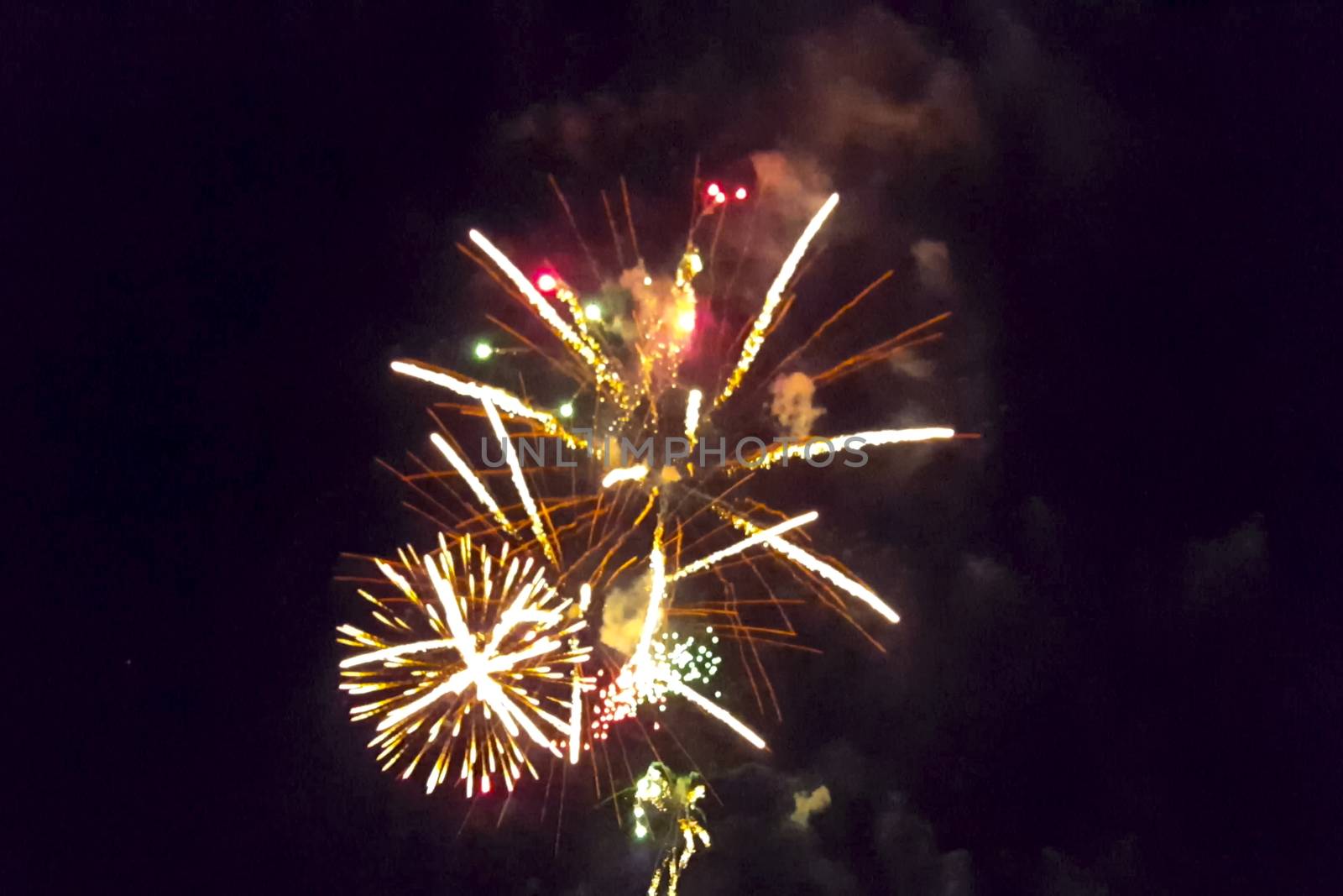 Festive salute in the night sky. Explosions of fireworks.