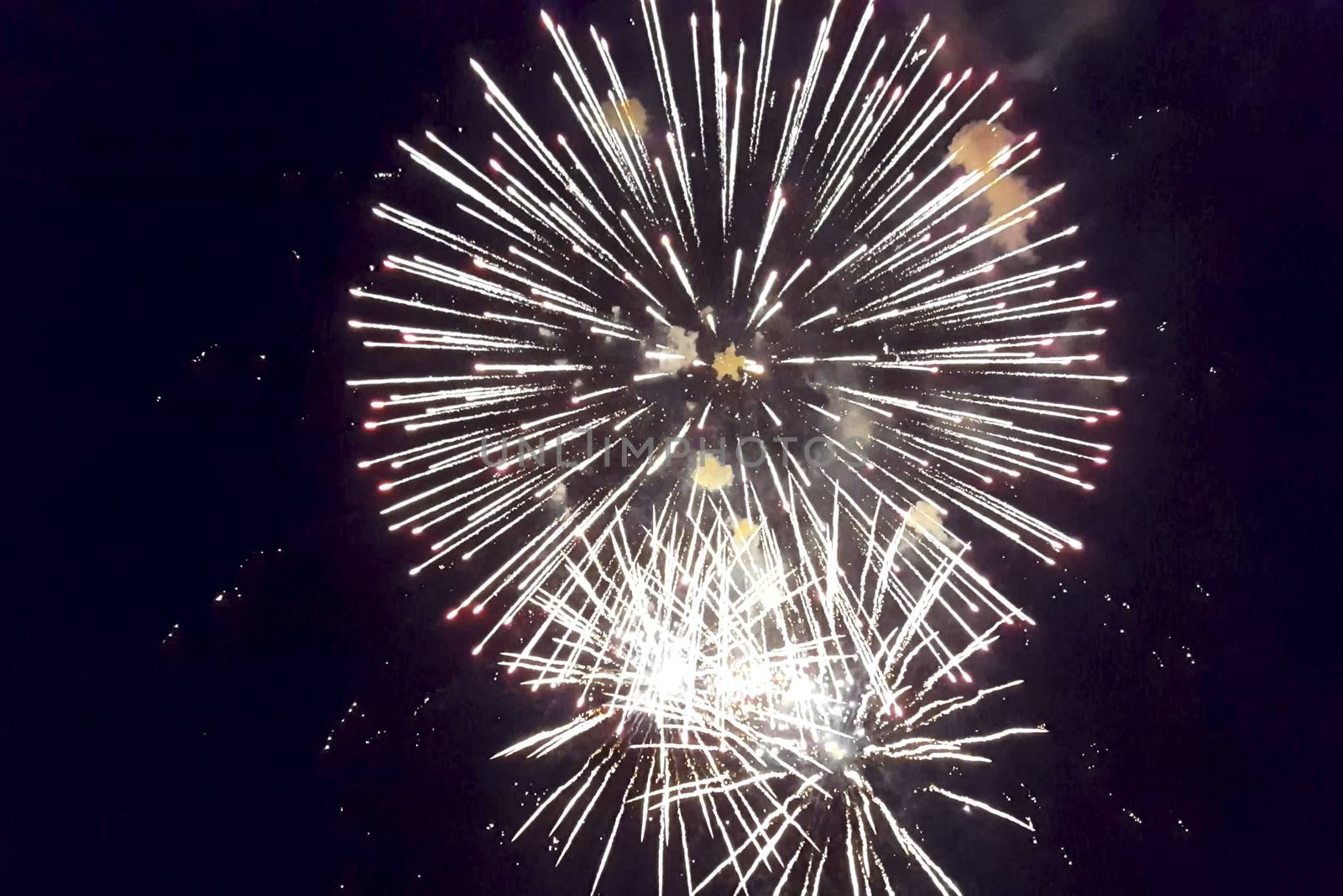 Festive salute in the night sky. Explosions of fireworks.