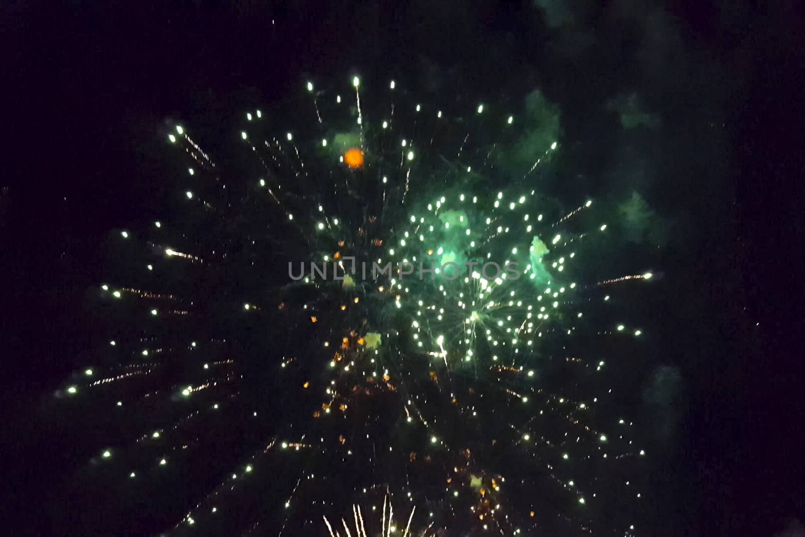 Festive salute in the night sky. Explosions of fireworks.