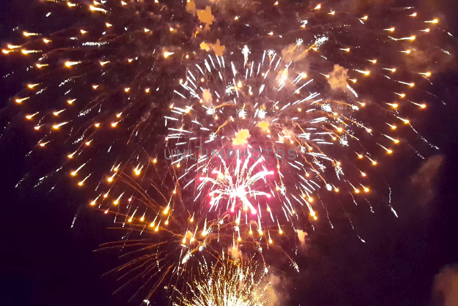 Festive salute in the night sky. Explosions of fireworks.